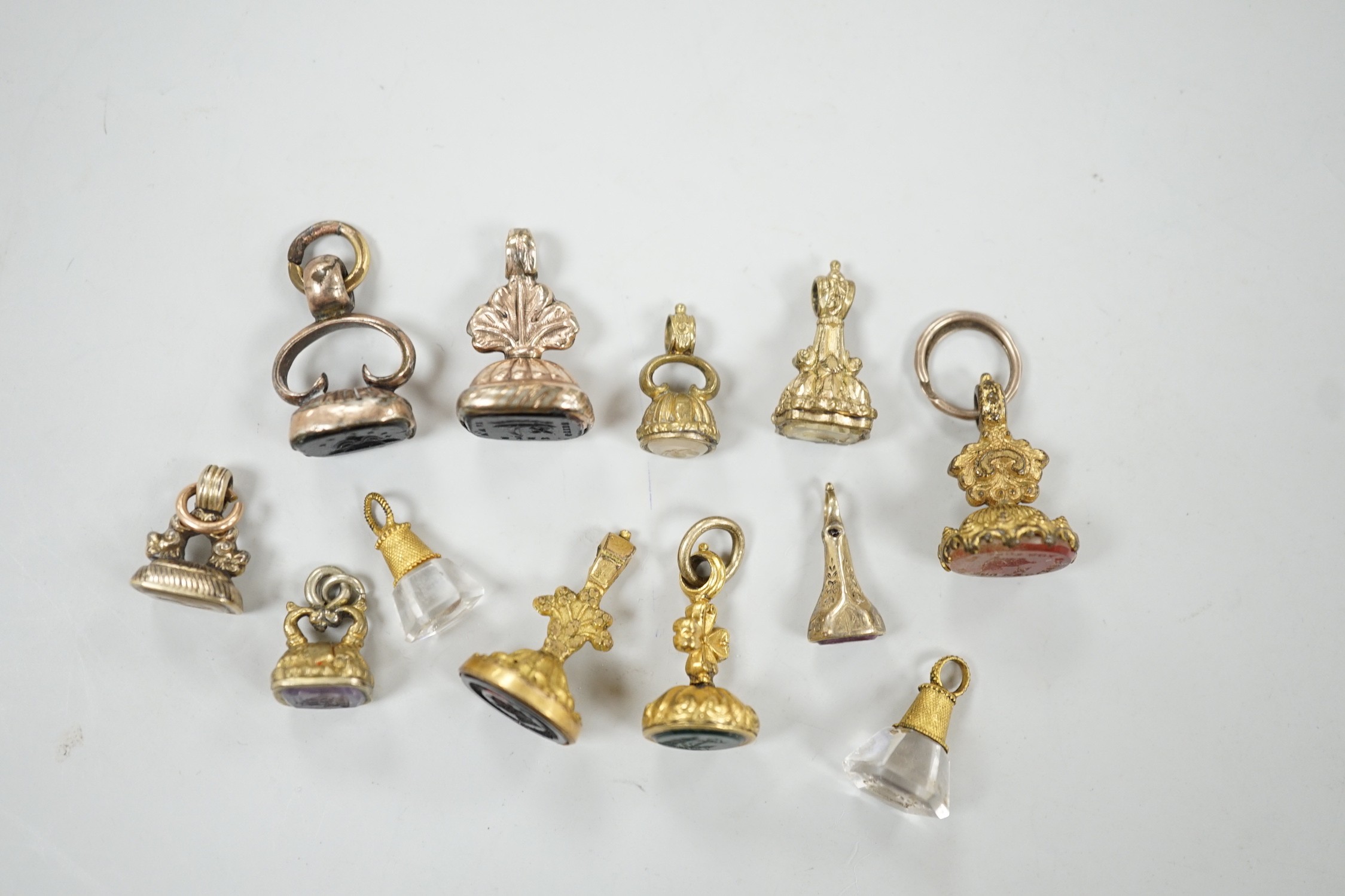 A collection of twelve small 19th century mainly yellow metal fob seals, with assorted matrices including bloodstone, amethyst, citrine and carnelian, largest 22mm.